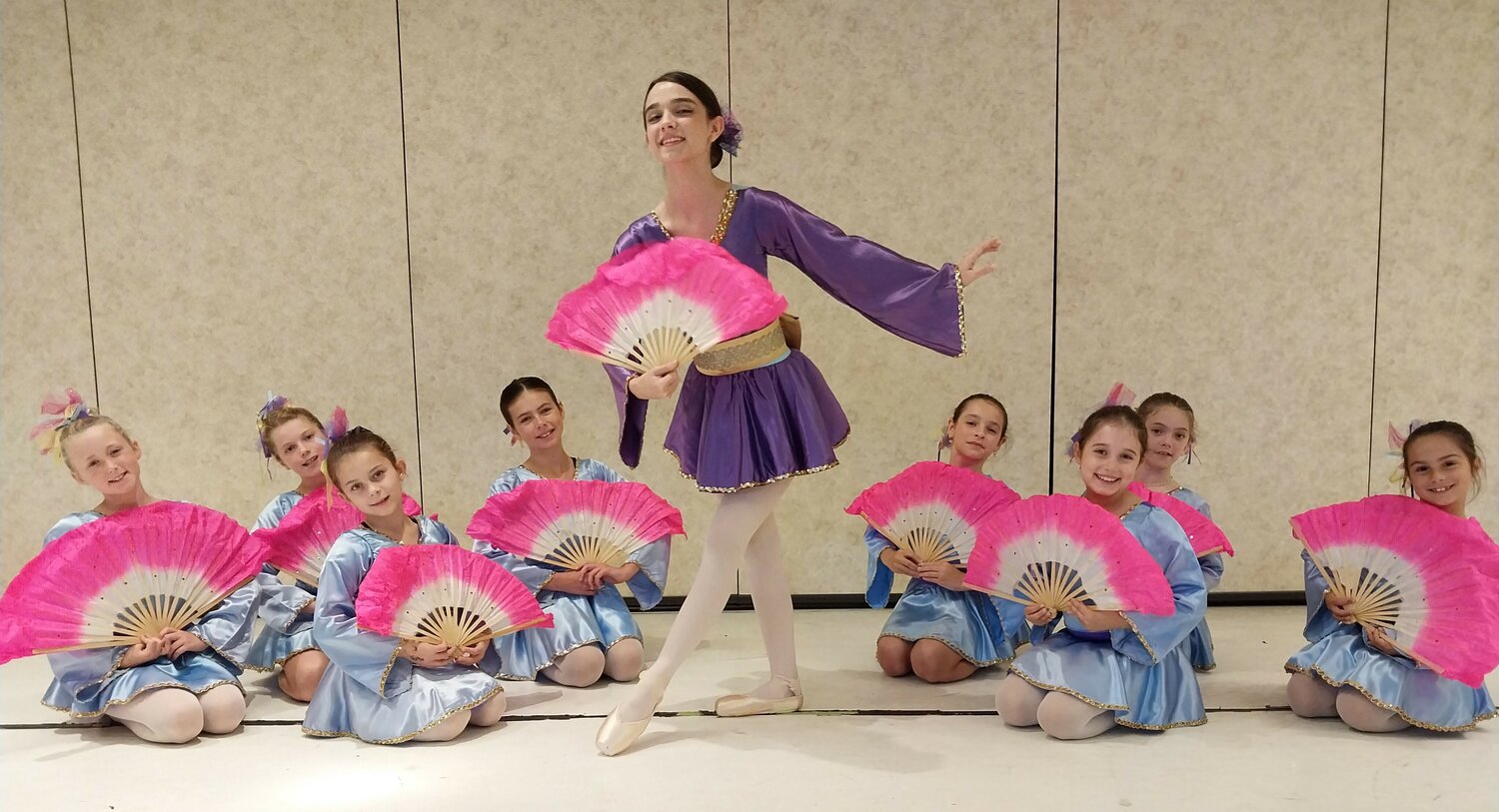 Soloist Madeline Rey, 16, performs the Chinese Dance with other young dancers.